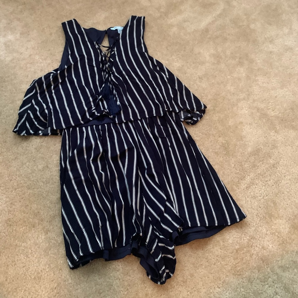 Navy romper with white stripes.